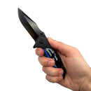 Hand holding a black skull punisher brand folding knife.