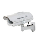 Dummy surveillance camera with solar powered light.