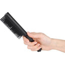 Black comb with hidden knife in hand