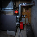 Self Activating Fire Extinguishing Ball with bracket mounted to furnace