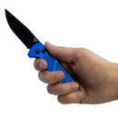 Hand holding a blue folding knife with a black blade on a white background