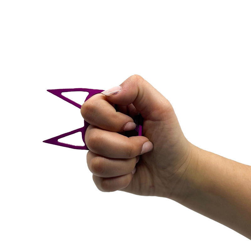 The Cat self defense keychain shown using a model how to hold and use for personal safety.