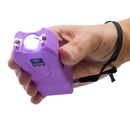 Purple stinger held in a hand against a white background