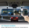 Car rearview mirror with touch screen displaying traffic scene, hand pointing at screen.