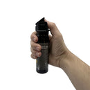 Hand holding a black pepper spray canister on a white background