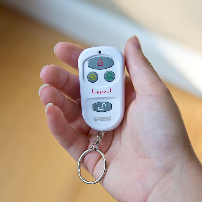 Sabre key fob remote control shown in hand.