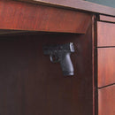 Teknon gun magnet used to mount and hold a handgun on the size of a wood desk.